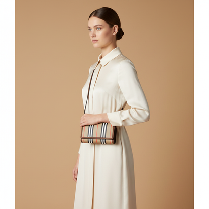 Burberry Hannah Icon Stripe Archive Tan E-Canvas Leather Wallet Crossbody Bag — held by model in studio