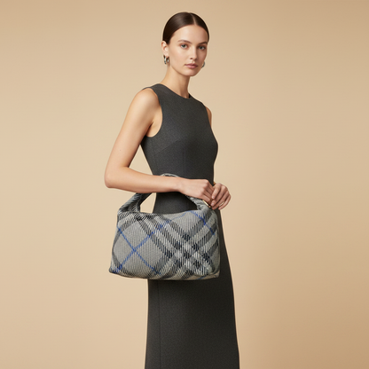 Burberry Medium Peg Tote in Lichen Check — held by model in studio