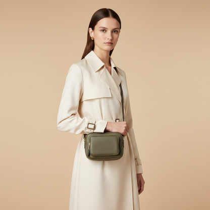 Burberry Small Branded Dark Fern Green Grainy Leather Camera Crossbody Bag — held by model in studio