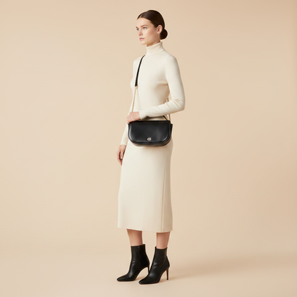 Tory Burch Kira Black Leather Shoulder Bag — held by model in studio