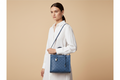 Marc Jacobs The Mini Grind Blue Sea Perforated Leather Crossbody Tote — held by model in studio