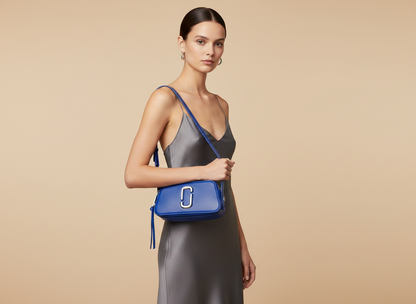 Marc Jacobs The Slingshot Cobalt Leather Shoulder Bag — held by model in studio