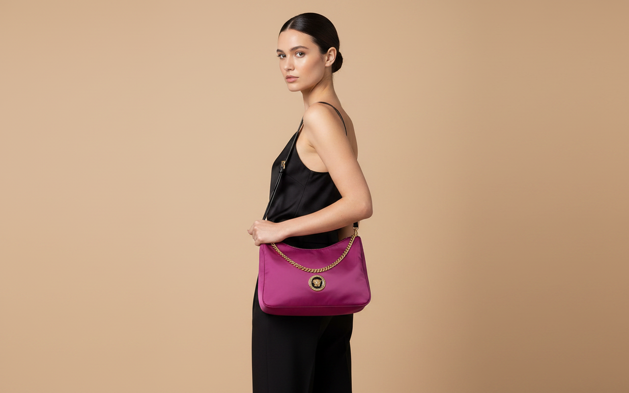 Versace Medusa Dahlia Nylon Crossbody Bag — held by model in studio