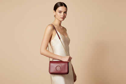 Marc Jacobs The Signet Syrah Leather Flap Crossbody Bag — held by model in studio