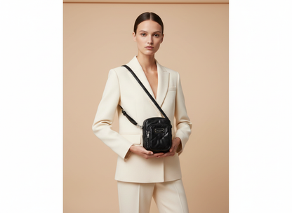 Marc Jacobs The Pillow Small Quilted Leather Crossbody Bag — held by model in studio