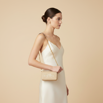 Marc Jacobs The J Marc Mini Beige Calf Leather Shoulder Bag — held by model in studio