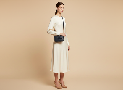 Marc Jacobs The Flash Leather Camera Crossbody Bag — held by model in studio