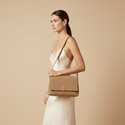 Tory Burch Charlie Beige Calf Leather Shoulder Bag — held by model in studio