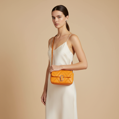 Marc Jacobs The J Marc Mini Scorched Quilted Leather Convertible Shoulder Bag — held by model in studio