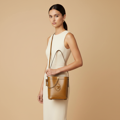 Versace Pivot Brown Leather Bucket Bag — held by model in studio