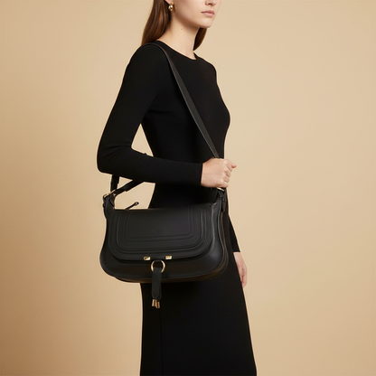 Black Calf Leather Bos Taurus Shoulder Bag — held by model in studio